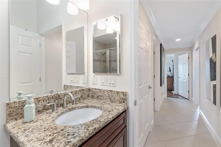 THIRD BATHROOM HAS GRANITE COUNTER TOP AND CHERRY CABINETRY.