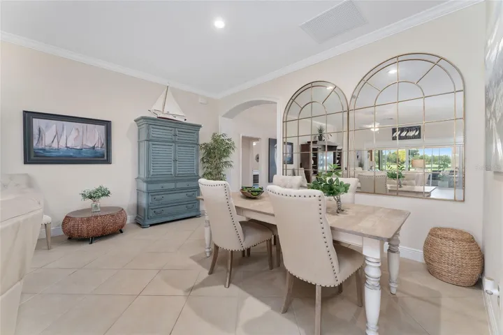 DINING SET AND MIRRORED WALL THAT REFLECTS BEAUTIFUL GOLF VIEWS AND ENHANCES NATURAL LIGHT IN THE HOME REMAIN WITH THE PROPERTY.