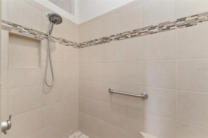 ROMAN SHOWER WITH INLAY TILE DETAIL