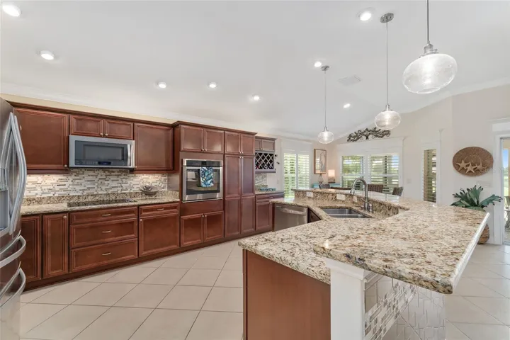 AMPLE ROOM IN KITCHEN WITH ACCESS ON BOTH SIDES OF ISLAND COUNTER.