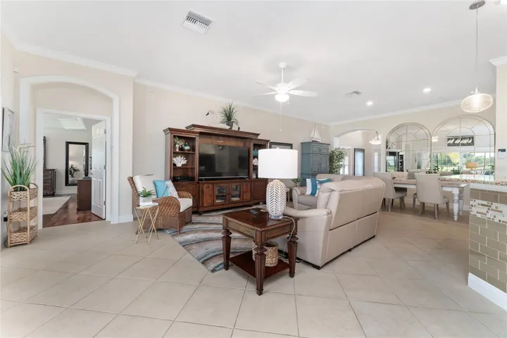 ENTERTAINMENT CENTER REMAINS IN HOME. VIEW FROM BREAKFAST AREA THROUGH LIVING AREA TO PRIMARY SUITE.