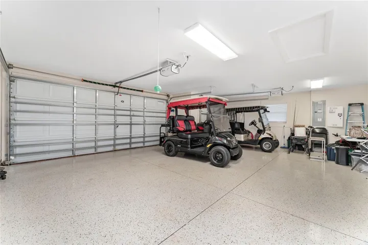 TWO CAR GARAGE AND GOLF CART GARAGE WITH EPOXY FLOORING AND PLENTY OF SPACE!