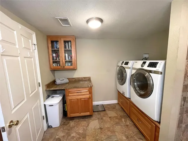 Nice laundry folding station with granite & storage!
