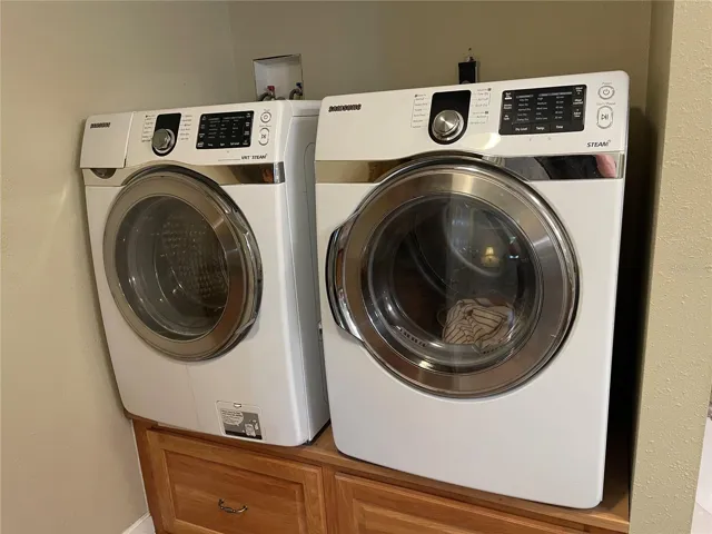 Full size washer/dryer combo with storage pedestals comes with house!