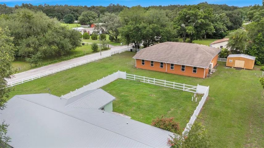 Aerial of rear fenced yard off the main house
