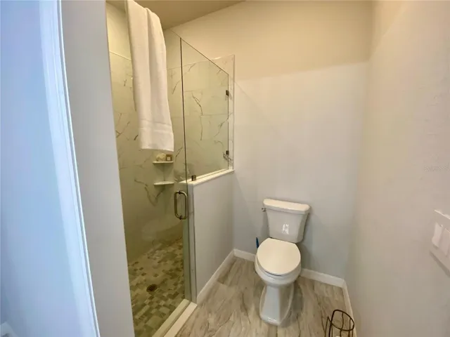 master bath with tiled shower & glass shower door