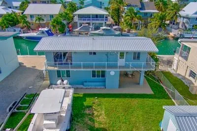 Front of home with parking for plane/boat and cars