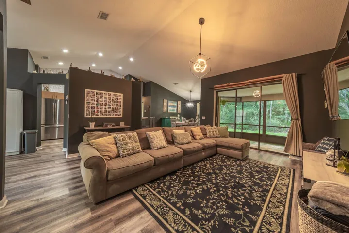 Living room has sliders to the screened in porch