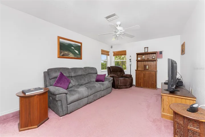 Living room has a ceiling fan
