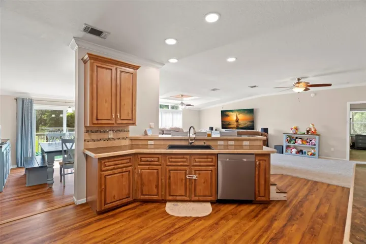 Kitchen with view of Dining Room, Living Room and door into Primary Bedroom.