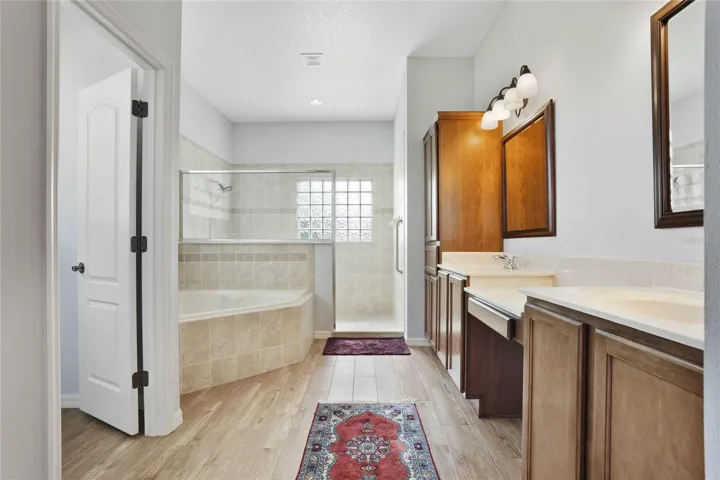 Primary Bathroom with dual sinks and vanities