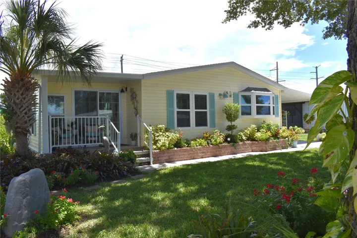 Meticulously maintained manufactured home in highly desirable 55+ community, Tangerine Woods!