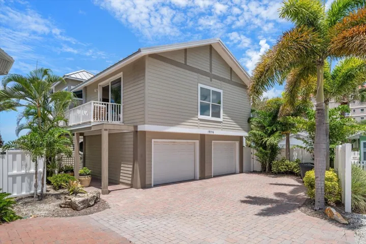 Front of Home with 2 car garage access and Guest House. Nice paver driveway