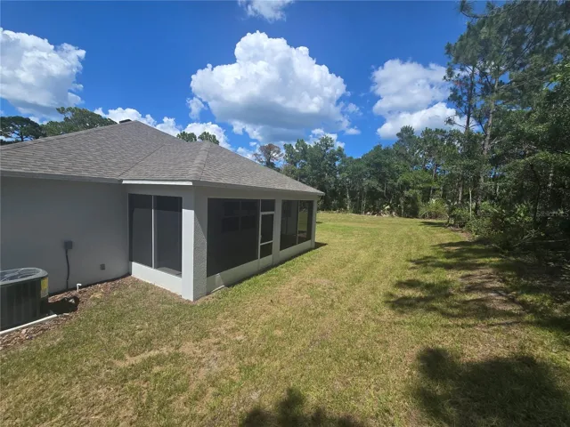 Private backyard with extended screened-in lanai.