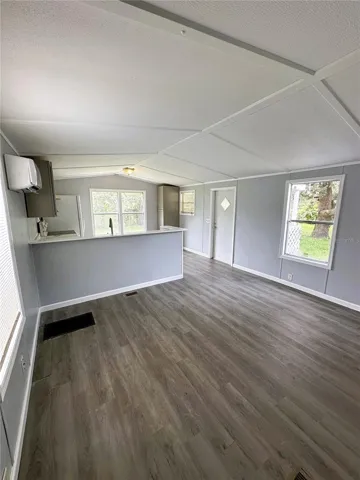 The living room is just off the kitchen and has a new split AC unit.
