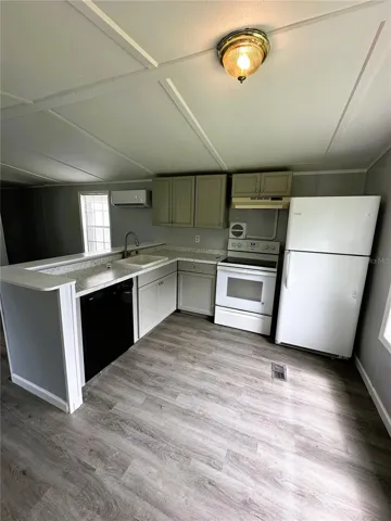 The kitchen is equipped with a dishwasher, refrigerator, and range. There is also a built-in pantry for additional storage.