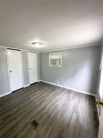 The Primary Bedroom is located in the back of the home and features two built-in closets.