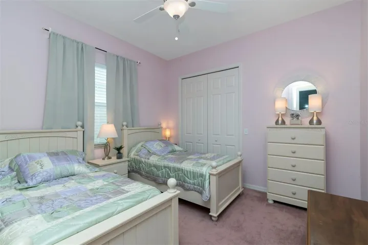 The second bedroom has a ceiling fan with light, reach in closet and window treatment.