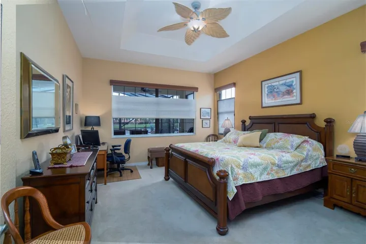 The master/primary bedroom has a tray ceiling and designer ceiling fan with light.