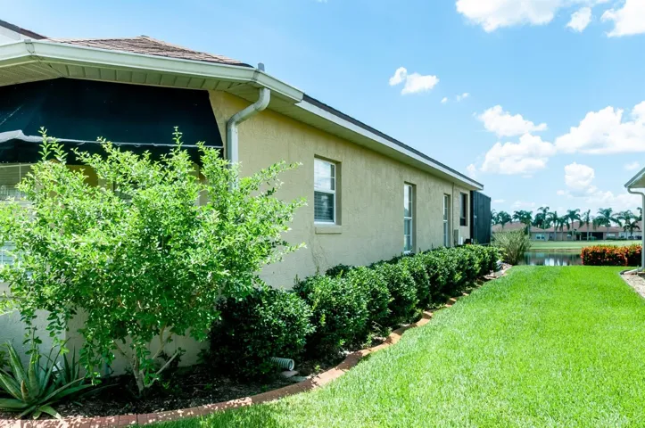 The quality landscaping that encircles the entire home includes a Barbados Cherry tree.