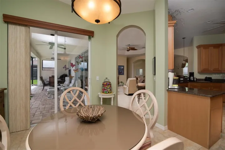The dinette has a double slider that opens to the pool and lanai area.
