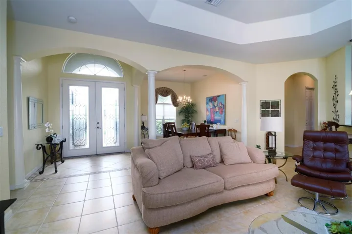 The leaded glass front door and over the transom window provides great natural light to the foyer.