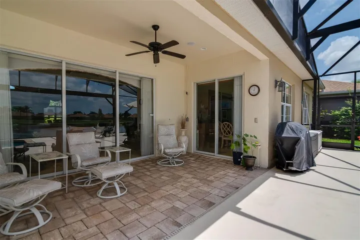 The covered area of the lanai has ceiling fans and paver flooring.
