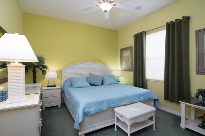 The third bedroom has a reach in closet, ceiling fan with light and window treatments.