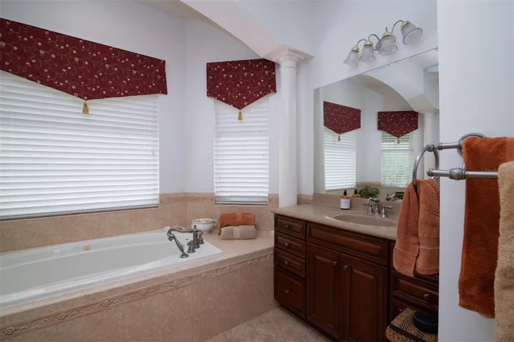 The master has twin elevated wood vanities with sculptured tops. Upgraded lighting and plumbing fixtures are a bonus.