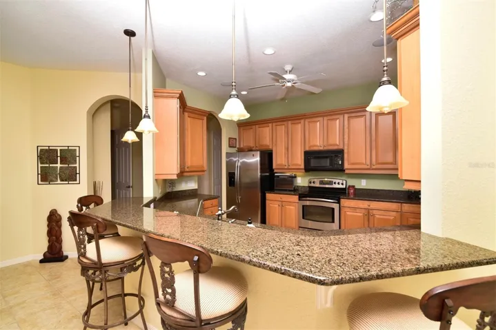 The chef's delight kitchen has pendant lights over the snack bar.