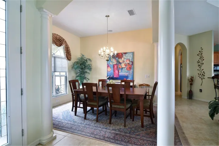 The foyer and the dining room are defined by graceful arches and stately pilars.