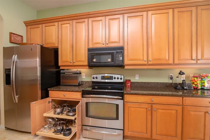 The kitchen cabinetry includes pull out shelves and under the cabinet lights.
