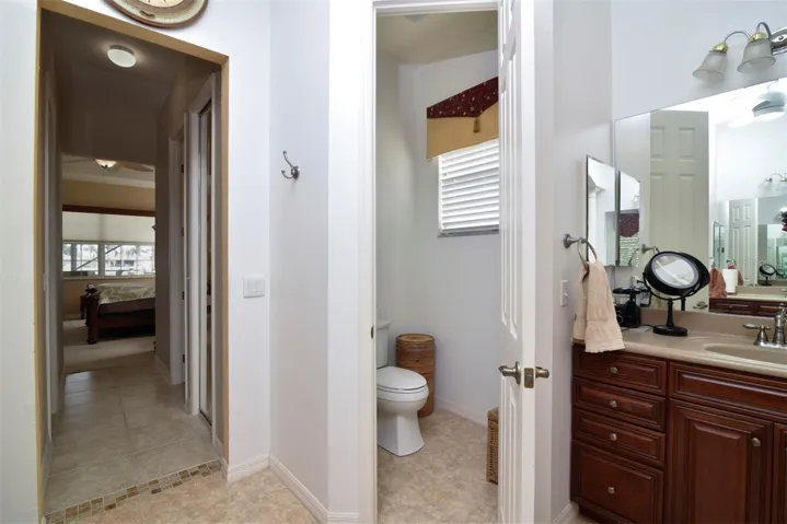 The privacy toilet area has an elongated comfort height stool.