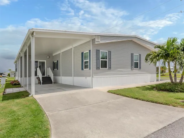Single carport with entrance to Florida room.