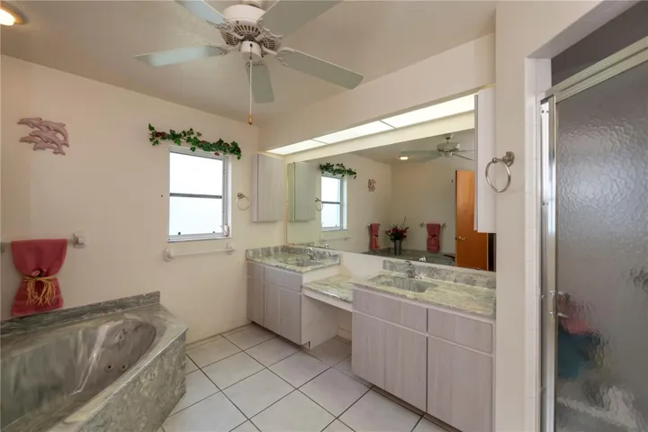 Ensuite bath features a jetted tub, dual sink vanity with make-up space, separate shower