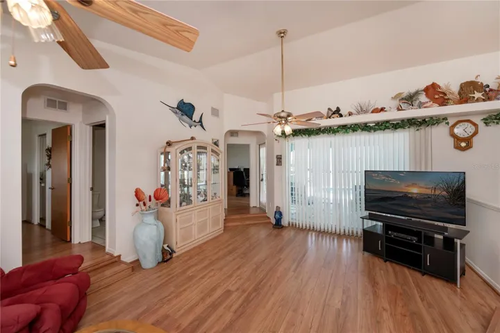 Cathedral ceiling, plant shelves, sliding doors to the pool & lanai: a few of the many features that this home has to offer you.