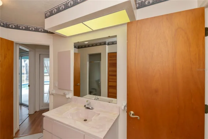 Noteworthy floor plan: pool bath access and Jack n Jill bath for both auxiliary bedrooms!