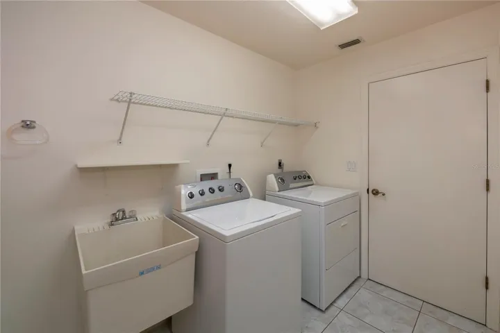Functional and spacious inside utility/laundry opens to the garage in this stem wall home.