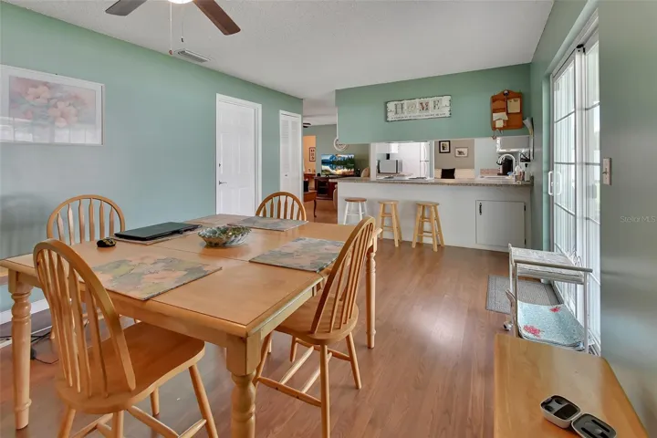 Dining Room lokking into kitchen.  Sliding glass door leading out to screen porch