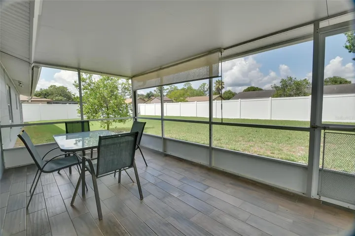 Fiinished screen porch with tile plank flooring.