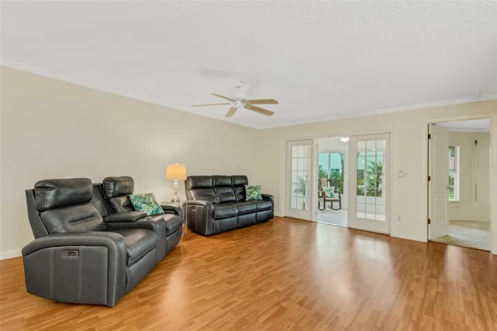 Open main living with relaxing green lawn views through bonus sunroom~