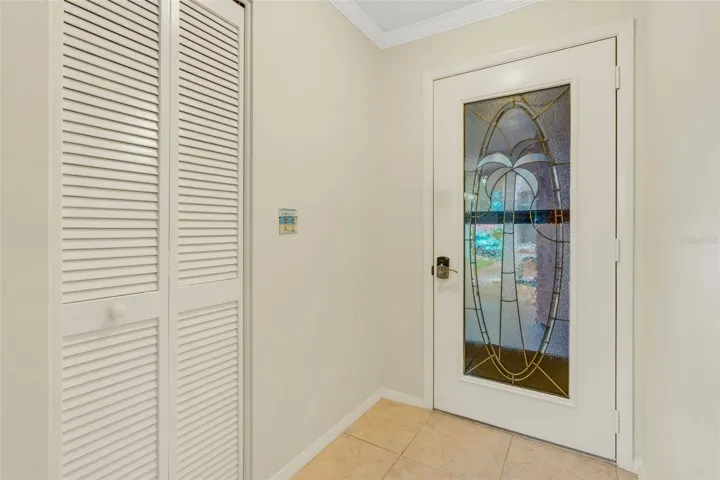 Entry foyer with an art glass door, entry closet & tile flooring~
