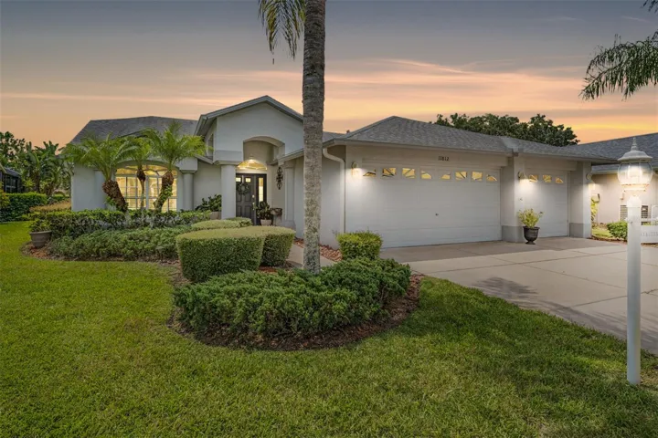 Picture perfect curb appeal with a 3-car garage and pond views