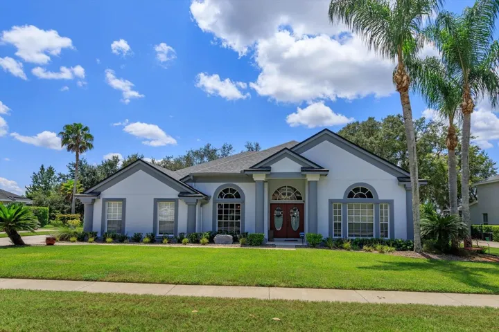 4 bedroom 3.75 bathroom with upgraded solar heated screen enclosed pool overlooking spacious fenced yard and pond view.