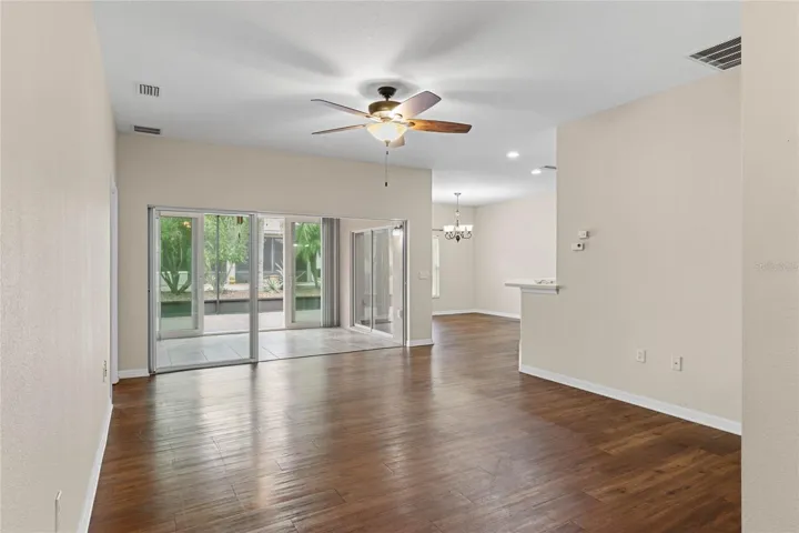 Living Room features Triple Glass Sliding Doors leading to the Florida Room
