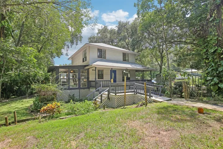 Primary Home - The front entrance of the home faces North. The West side of the home faces the street, and the East side of the home has an incredible Florida Room that overlooks the backyard.