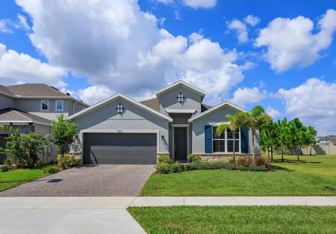 Exterior front with stone accents and paver driveway
