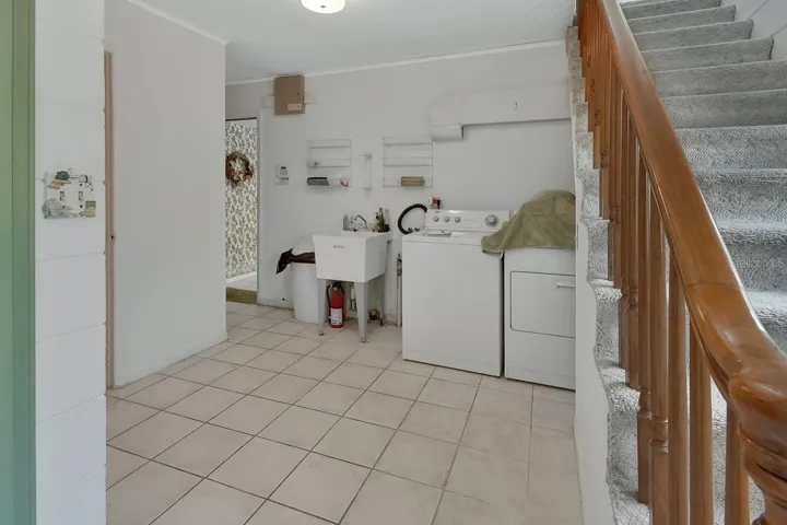 Laundry looking to the kitchen, also an exit to the pool, 1/2 bath and garage