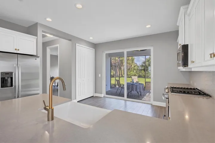 Kitchen with large pantry and sliders to extended lanai