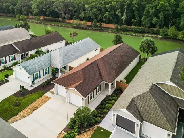 Front of home showing water behind with preserve like area beyond that